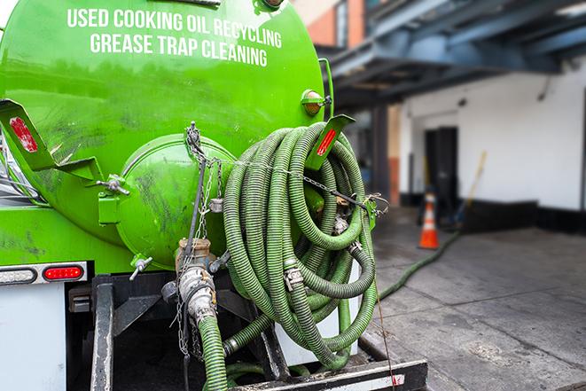 maintenance crew pumping grease trap at a fast food restaurant in Elk Grove